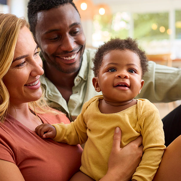 Parents playing with adopted daughter